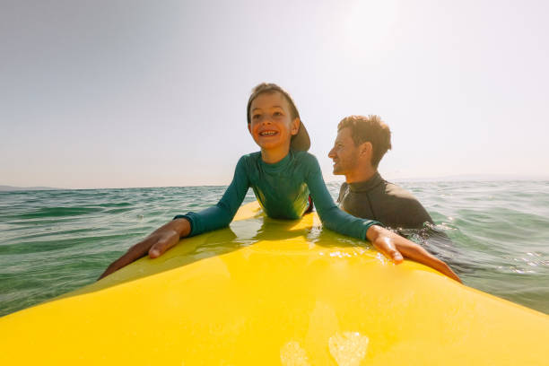 istock Cute little surfer and his dad 1192079835