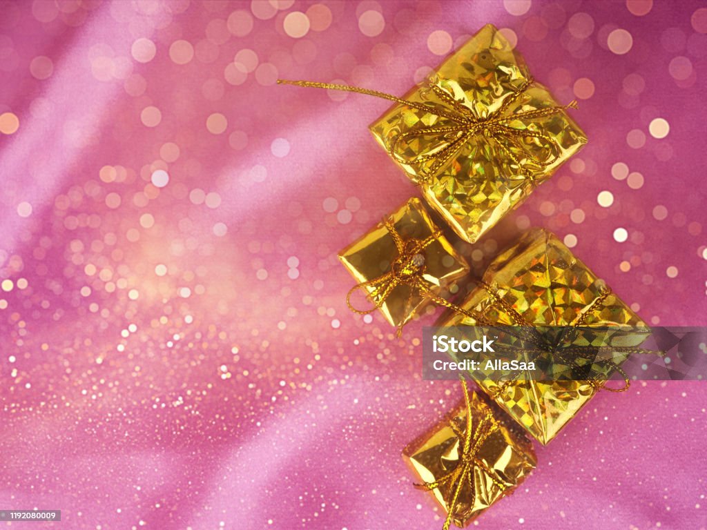 Christmas tree on a background of shiny pink satin as background, silk background, Christmas card. Happy new year greetings, gifts, Christmas symbols on pink silk Christmas tree on a background of shiny pink satin as background, silk background, Christmas card. Happy new year greetings, gifts, Christmas symbols on pink silk. Horizontal Stock Photo