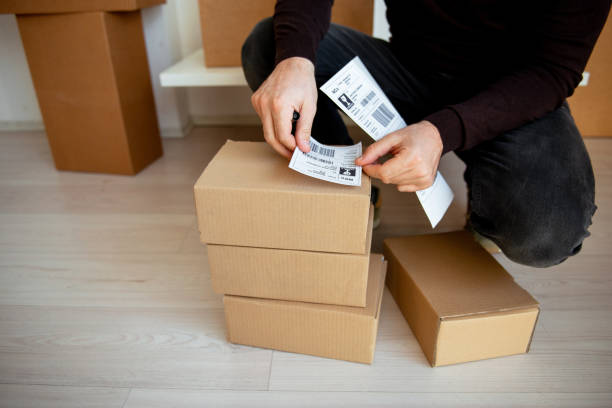 istock Delivery service, applying a shipping label 1192080251