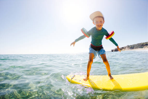 istock Cute little surfer in action 1192080258