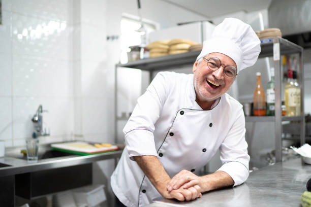 istock Portrait of smiling senior chef in a kitchen 1192082795