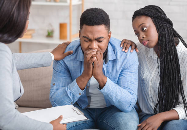 istock Loving afro wife and unrecognizable psychotherapist supporting guy during therapy session 1192083299