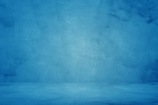 istock blue grunge texture cement or concrete wall banner, blank  studio background 1192084272