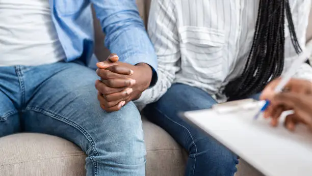 Support And Trust. Unrecognizable Married Couple Holding Hands, Comforting Each Other During Therapy Session In Counselor's Office, Panorama