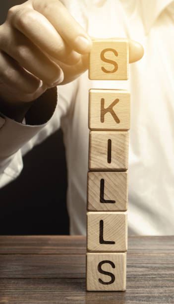 istock A man puts wooden blocks with the word Skills. Knowledge and skill. Self improvement. Education concept. Training. Leadership skills. Human abilities 1192085681
