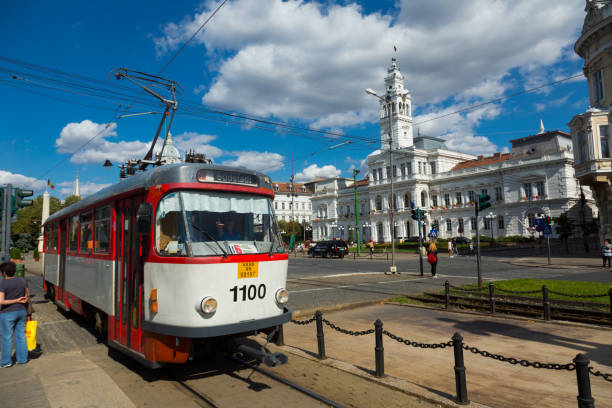 ARAD, ROMANIA - SEPTEMBER 13, 2017: Colored trams running on main square near city hall
