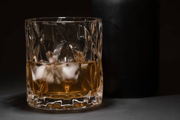 crystal glasses of whisky on black table - decanter crystal carafe glass imagens e fotografias de stock