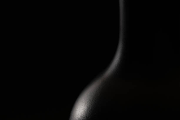 elegant black bottle of whiskey or rum on a black background. - brandy bottle alcohol studio shot imagens e fotografias de stock