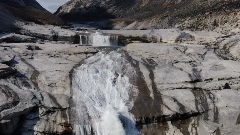 Slow aerial drone ride over waterfalls of the river near the Sam Ford Fjord, Canada, near Greenland