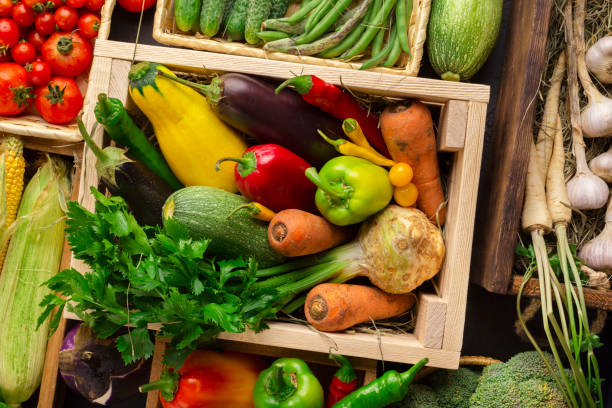 istock Bright and fresh organic vegetables on counter in wooden boxes 1192087231