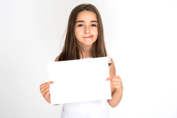 istock Little girl holding blank white paper 1192087238