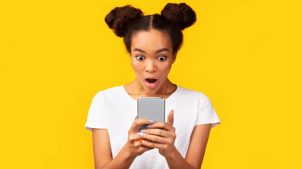 istock Amazed african american girl reading shocking sms 1192088533