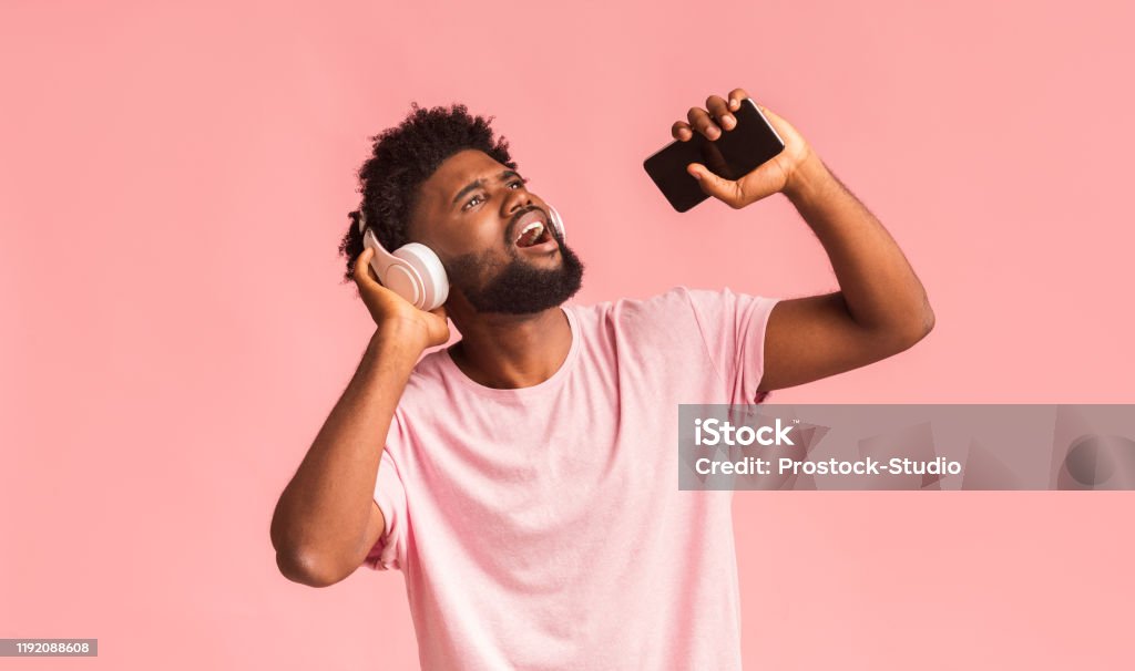 Funny Guy With Wireless Headset Singing Over Pink Background Stock Photo -  Download Image Now - iStock