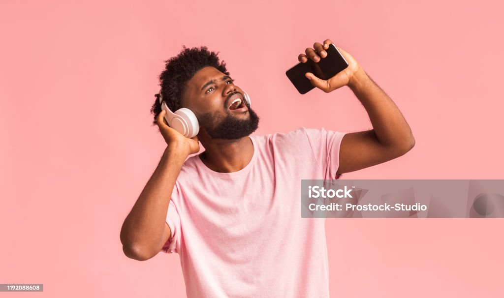 Funny Guy With Wireless Headset Singing Over Pink Background Stock Photo - Download Image Now - iStock Funny Guy With Wireless Headset Singing Over Pink Background Stock Photo - Download Image Now - iStock