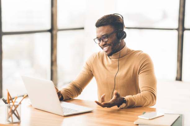 istock Cheerful consultant with headset speaking to customer 1192088668