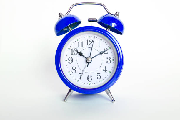 istock blue round analog alarm clock on white background. time 10:10. classic blue color 2020 1192088702