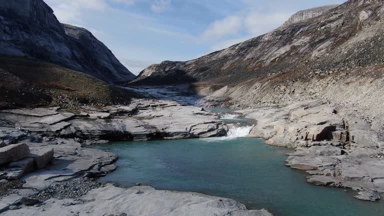 Slow aerial drone ride over the river near the Sam Ford Fjord, Canada, near Greenland