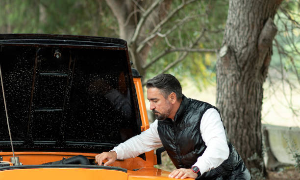 man is repairing car