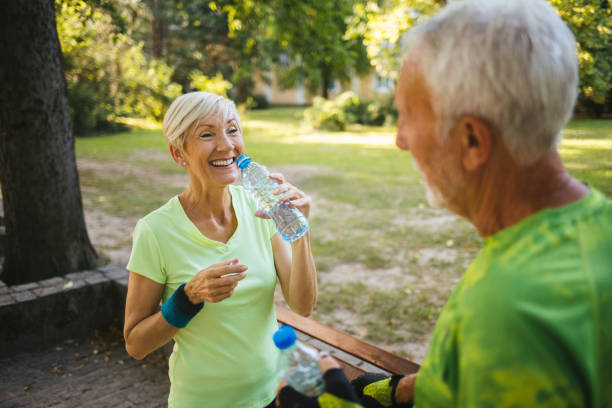 istock Senior couple staying hydrated after running, jogging 1192090264