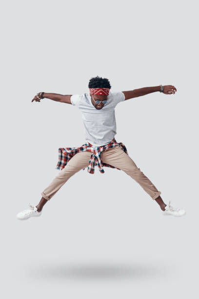 istock Full length of playful young African man going crazy while hovering against grey background 1192090399
