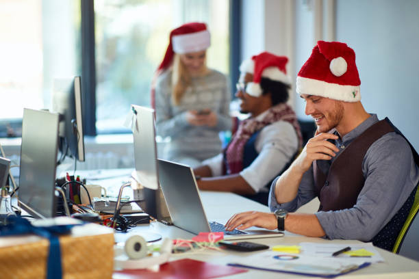 istock Young man working at a computer at Christmas  at office. 1192090683