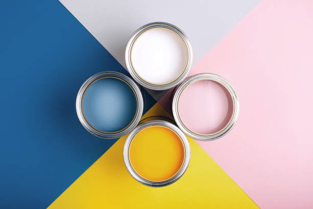 istock Four open cans of paint on bright symmetry background. 1192091978