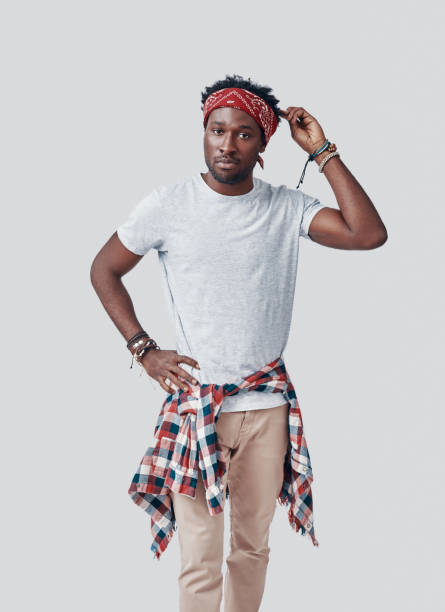 istock Handsome young African man looking at camera while standing against grey background 1192092242