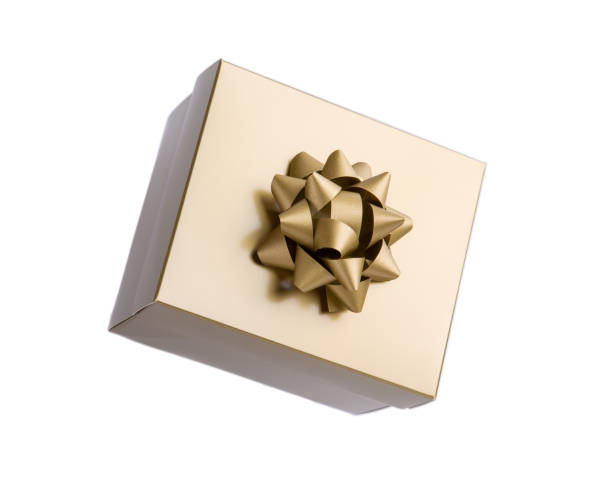 istock Golden gift box with gold bow isolated on white background. Close-up. 1192092835