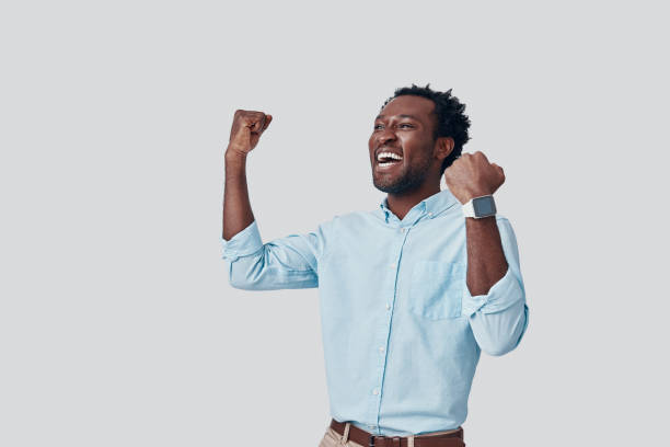 istock Handsome young African man gesturing and smiling while standing against grey background 1192092929