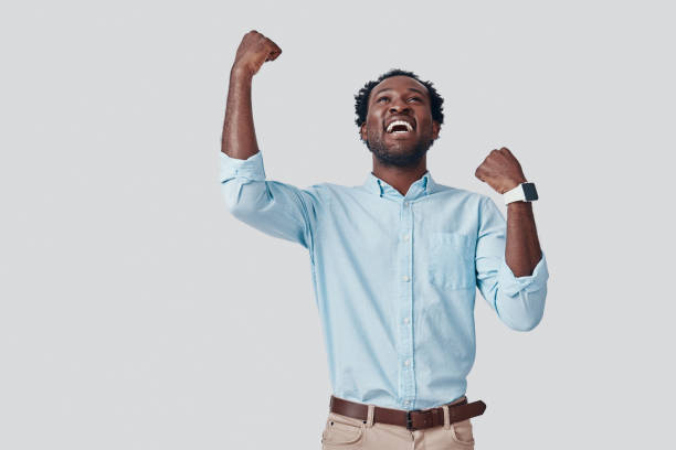 istock Handsome young African man gesturing and smiling while standing against grey background 1192092970