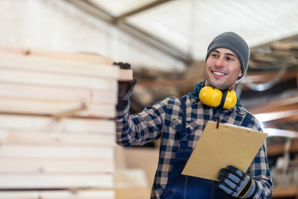 istock Young male worker in timber warehouse 1192094030