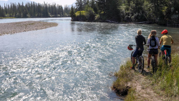 istock Mountain bikers relax by the river 1192094143