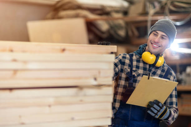 istock Young male worker in timber warehouse 1192094380