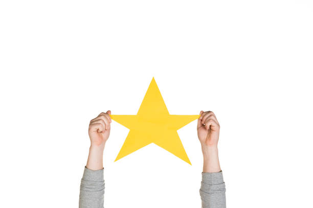 istock Hands holding the sign of star on white studio background 1192094611