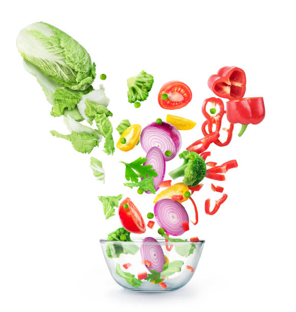 istock Vegetables cut flying into a glass plate isolated on a white background 1192094700