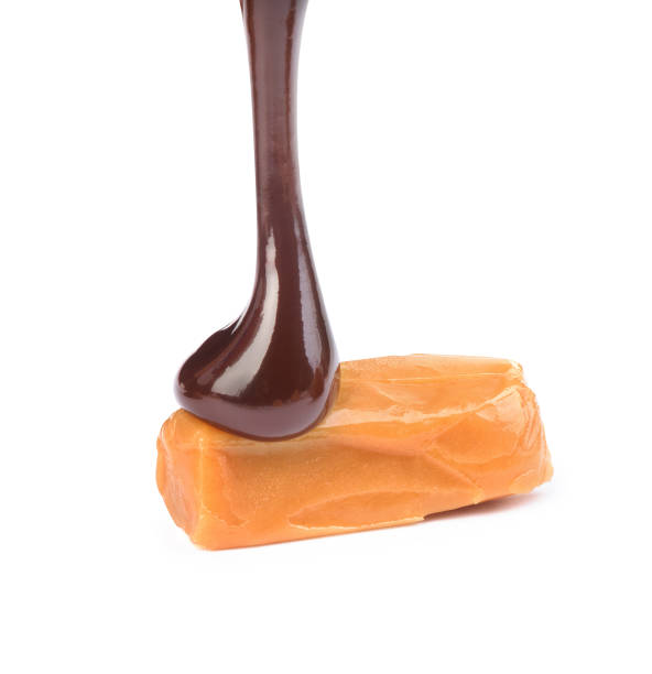 istock chocolate poured caramel candy on a white background 1192094701