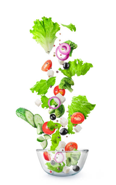 istock Vegetables cut flying into a glass plate isolated on a white background 1192094734