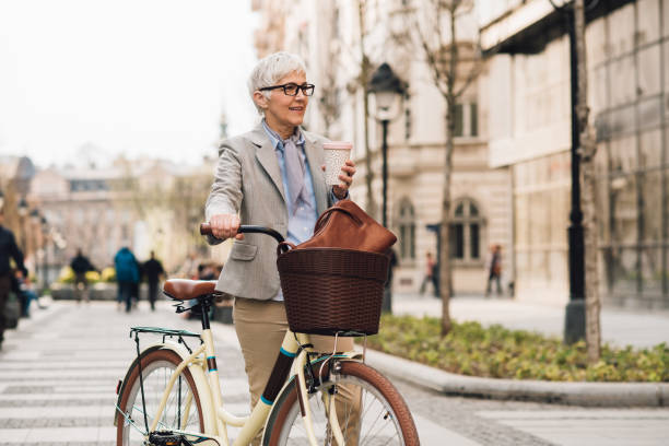 istock Senior businesswoman commuting with bicycle and drinking coffee 1192097885