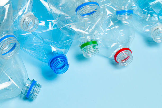 istock Crumpled plastic bottles on a blue background. Plastic trash 1192097924
