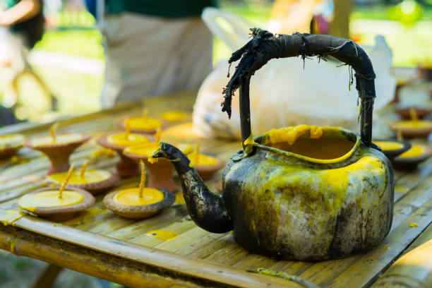 istock Beeswax Kettle and lamp was placed in bamboo bench for use as a candle casting device In the Buddhist tradition for offering to monks during the rainy season in Thailand 1192101516