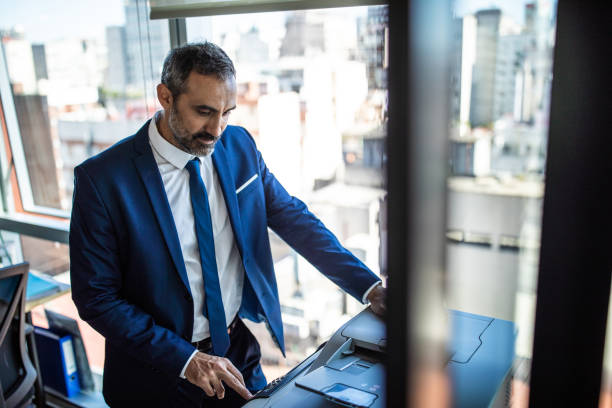 Hispanic Businessman printing in the office