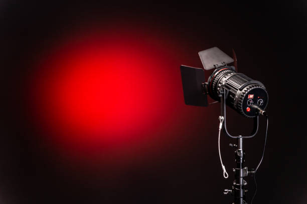 istock Lighting equipment, spot light on black and red background 1192102055