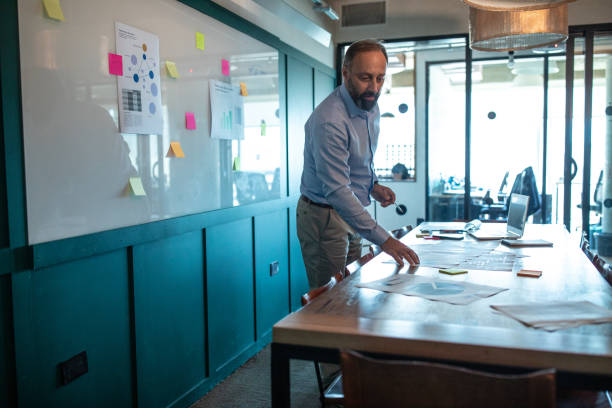 istock Mature architect working in conference room 1192102340