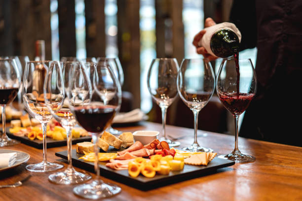 Sommelier serving glasses of winetasting event Close-up on a sommelier serving glasses of winetasting event serving food and drinks photos stock pictures, royalty-free photos & images