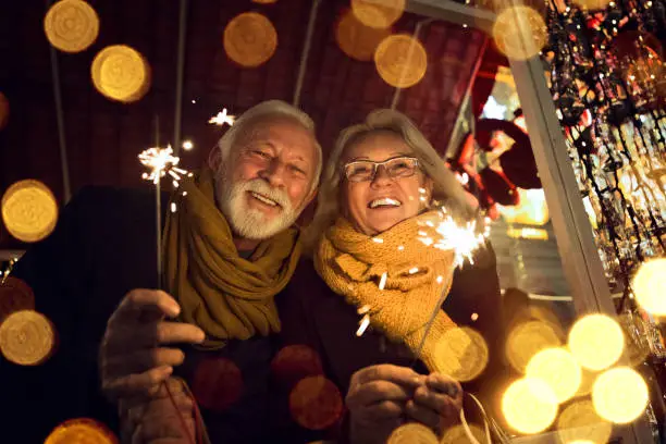 Photo of Romantic senior couple with sparklers during Christmas holidays