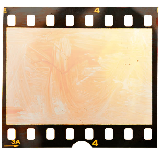 single 35mm film or movie strip with red orange acrylic paint that looks like blood single 35mm film strip isolated photographic slide stock pictures, royalty-free photos & images