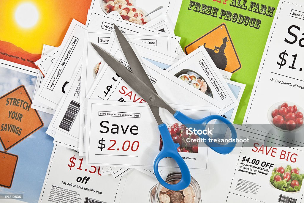 Fake coupons on a printed background with scissors.  Advertisement Stock Photo