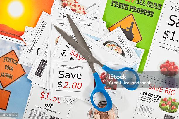 Fake Coupons On A Printed Background With Scissors Stock Photo - Download Image Now