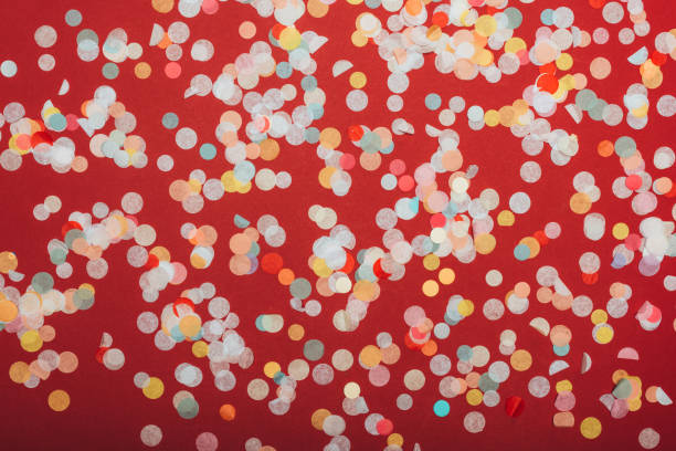 istock top view of christmas confetti on red 1192109109