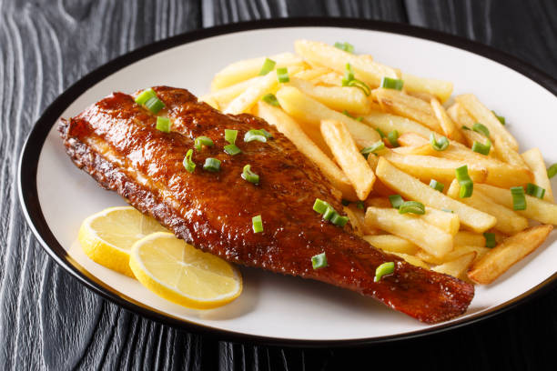 Healthy food fried red perch fish with French fries close-up in a plate. horizontal Healthy food fried red perch fish with French fries salad close-up in a plate on the table. horizontal sebastinae photos stock pictures, royalty-free photos & images
